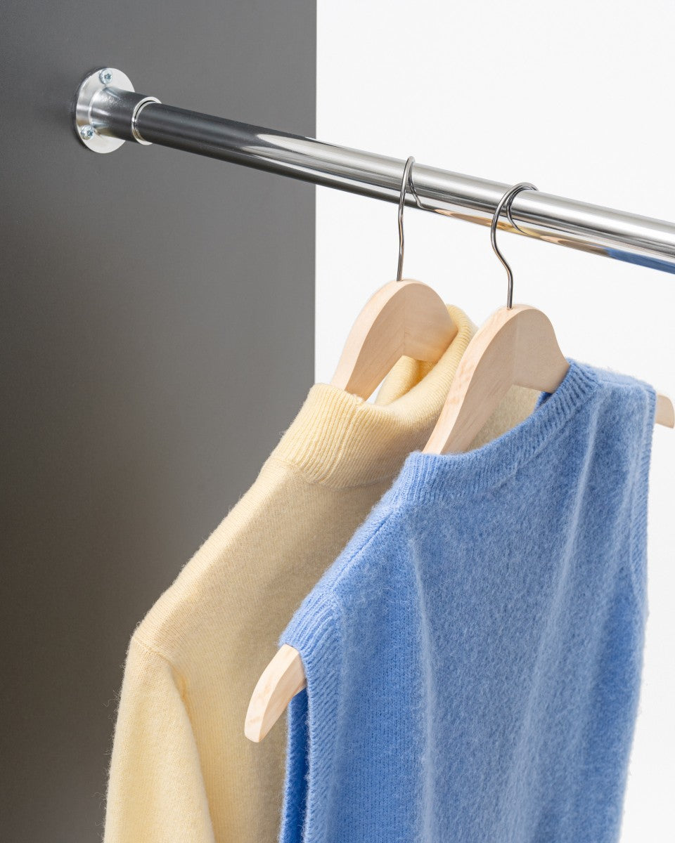 Standard clothes rack attached to cabinets